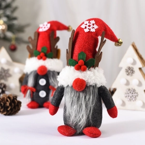 Detail of plush Christmas gnome with antlers featuring soft knitted hats and felt texture