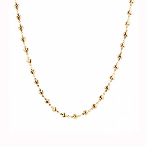 Detail showing the interconnected golden heart shaped links of a minimalist necklace
