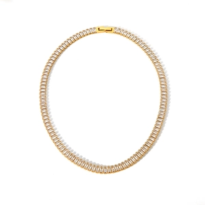 Macro shot of gold tennis necklace with rectangular-cut cubic zirconia and folding clasp