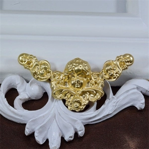 Baroque style angel brooch in matte gold finish on white pedestal with fabric background