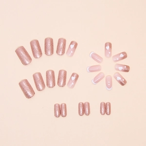 Pink glitter press-on nails with white heart designs and French tips, medium square shape