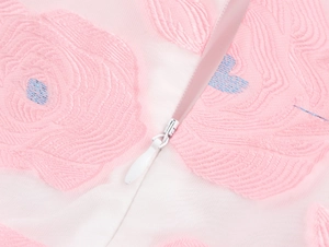 Close-up of invisible zipper on floral jacquard fabric with pink and blue embroidery