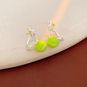 Detail of silver star earring with green apple bead and lucky text engraving