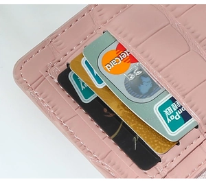 Pink faux crocodile leather wallet detail showing multiple card slots and tidy stitching