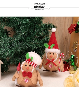 Detail of gingerbread plush birds wearing chef and Santa hats for Christmas window decor