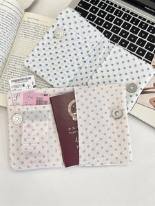 Polka dot fabric passport holder with magnetic buckle and card slots for travel