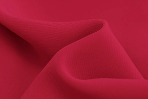 Detailed close-up of dark red chiffon fabric showing smooth texture and soft drapes