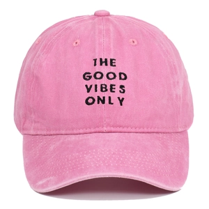 Detailed embroidery of THE GOOD VIBES ONLY on a washed pink cotton baseball cap