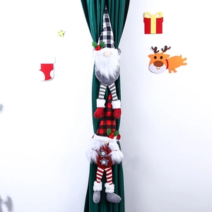 Pair of Christmas gnome curtain tiebacks with red and black plaid hats on green curtains