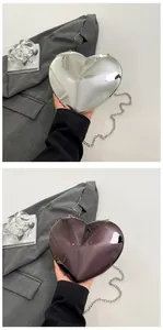 Close-up of heart-shaped metallic evening clutch bags with mirror finish and long chain