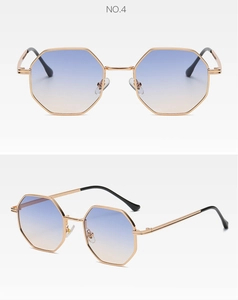 Detail view of gold octagonal metal frame sunglasses with gradient blue lenses