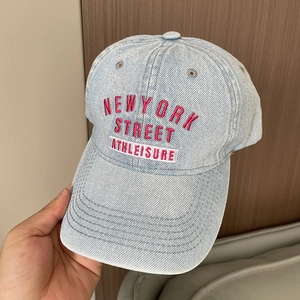 Detail of washed denim baseball cap featuring New York Street Athleisure embroidery