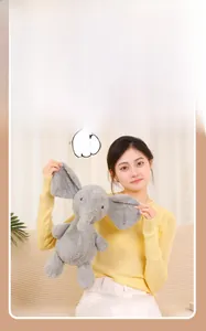 Detail of grey plush elephant toy showing soft texture and large ears in cozy home setting