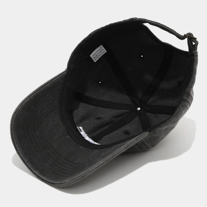 Detail of 100% cotton baseball cap showing inner stitching and adjustable metal buckle