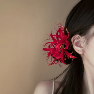 Elegant red acrylic spider lily hair clip in New Chinese style shown on a model side view