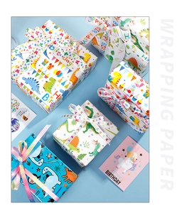 Detail of colorful dinosaur and unicorn birthday wrapping paper with gift boxes and ribbons