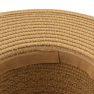 Detail of the woven straw texture and sweatband on a tan Panama sun hat