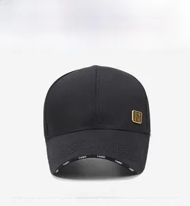 Detail of black baseball cap with golden metal badge and white FARD text on the brim