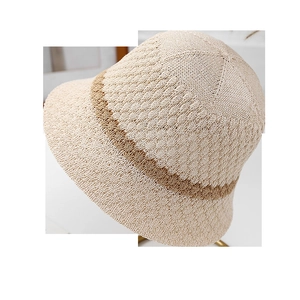 Detailed macro texture of a beige crochet bucket hat with contrasting brown stripes