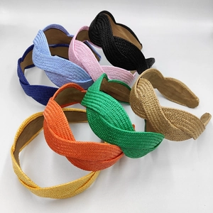 Handmade woven raffia headbands in multiple vibrant colors with braided texture