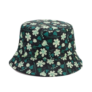 Floral reversible bucket hat with black botanical pattern for outdoor sun protection