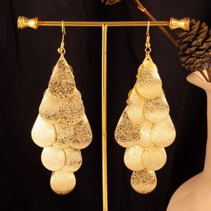 Baroque gold layered leaf earrings with sequins on a vintage stand display