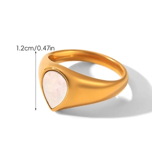 Detailed view of vintage gold stainless steel ring with white teardrop stone inlay