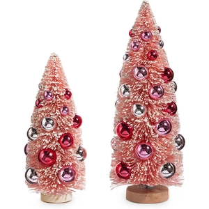 Detail of two pink bottle brush Christmas trees with colorful ornaments and wooden bases