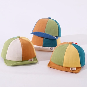 Detail of baby soft brim baseball caps in colorful patchwork breathable cotton fabric