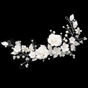 Silver bridal hair vine with white ceramic flowers, pearls, and crystals on black backdrop