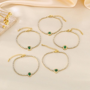 Vintage gold-plated titanium bracelets with emerald green stones and white zircons