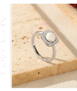 Detailed macro view of an elegant S925 silver ring featuring a white opal with halo zircons