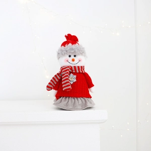 Close-up of a Christmas snowman doll with striped scarf and knitted fabric detail