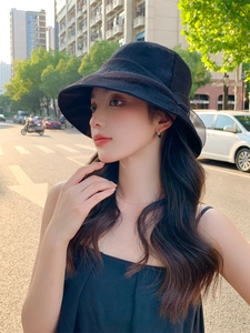 Detail of a chic black pleated sun hat with a wide brim for summer outdoor protection