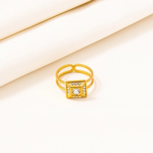 Detail of gold square face ring with central round crystal and adjustable open band