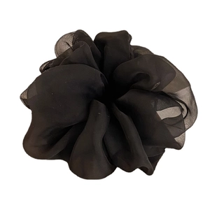 Elegant black silk satin hair scrunchie with smooth pleated texture and glossy finish