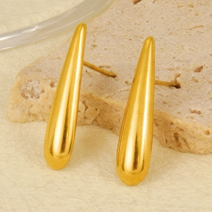Close-up of gold teardrop stud earrings in 304 stainless steel on a textured stone base