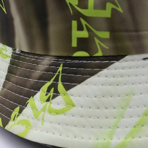 Detailed macro view of vibrant neon graffiti print on a durable bucket hat with six-row stitching