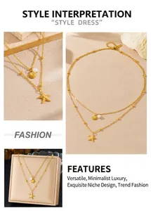 Close-up of double-layer gold chain with starfish charm and pearl scallop pendant