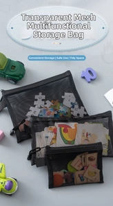 Detailed view of black mesh storage bags in three sizes for puzzles and stationery