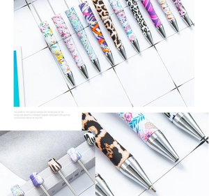 Detail of patterned plastic beadable pens with leopard print and floral designs for DIY
