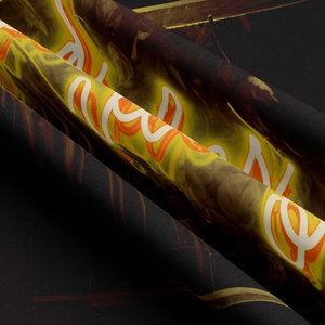 Close-up detail of flame print and artistic white lettering on black fabric tapestry