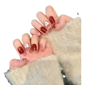 Handmade red cat eye press-on nails with 3D ghost designs and festive bows