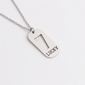 Macro detail of silver titanium steel rectangular pendant with number 7 and Lucky engraving