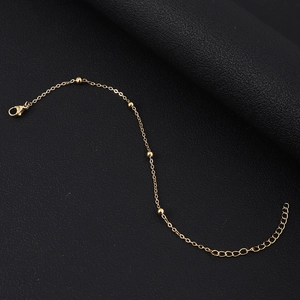 Detailed shot of 18K gold plated chain bracelet with lobster clasp and round beads