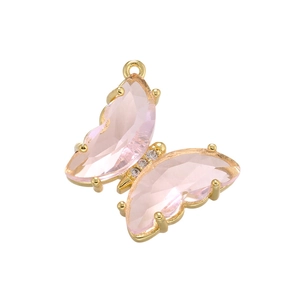 Close-up of a 18K gold butterfly pendant with faceted pink glass on a white background