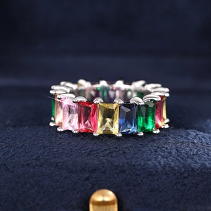 Macro-opname van rechthoekig geslepen regenboog edelstenen in een ringbandzetting