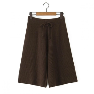 Detail of dark brown knit wide-leg shorts with ribbed texture and drawstring waist