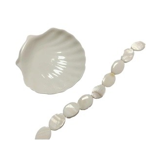 Polished white oval mother of pearl shell beads with a shell shaped ceramic tray