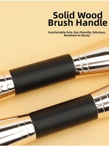 Detail of matte black wooden makeup brush handle with premium gold metal ferrule